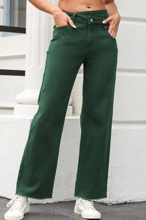 Green cotton jeans with a crossed v-waist and straight leg, featuring a raw hem.