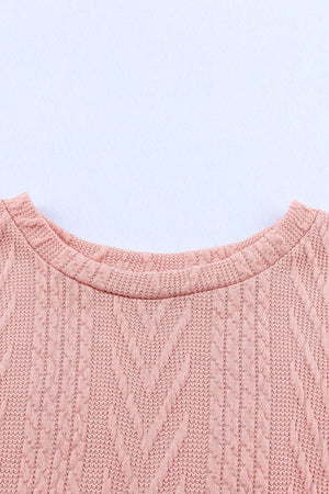 Pale Blush textured chevron knit sweater with crew neck and cable knit details.