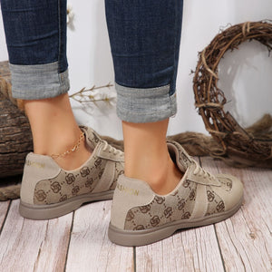 Chic beige lace-up sneakers with monogram pattern and "FASHION" detail.