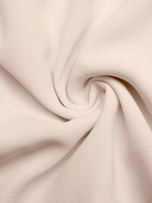 Beige midi dress fabric detail with subtle texture and soft drape.