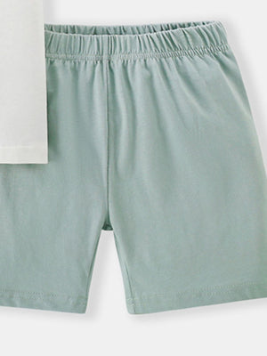 Toddler pale green cotton shorts with elastic waistband and white t-shirt detail.