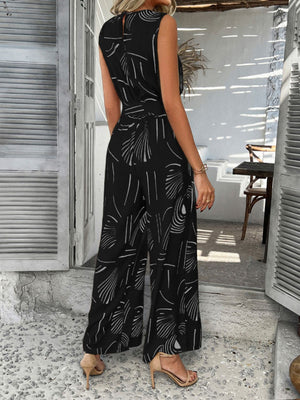 Black abstract print wide-leg jumpsuit with a belted waist and sleeveless design.