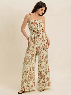 Tropical tie strap wide-leg romper in light green with brown floral and bird print.