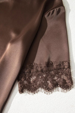 Brown satin maternity blouse with lace trim detail on the sleeve hem.