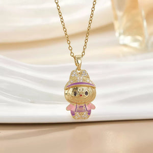 Gold-plated character pendant necklace with pink and purple enamel details and crystal accents.