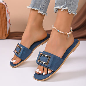 Navy buckle decor open toe flat sandals with a gold square buckle detail.