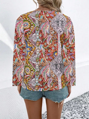 Bohemian paisley v-neck shirt in multicolor with long sleeves, styled with denim shorts.