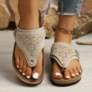 Beige hollow-out toe-post sandals with adjustable ankle strap and cork-style sole.