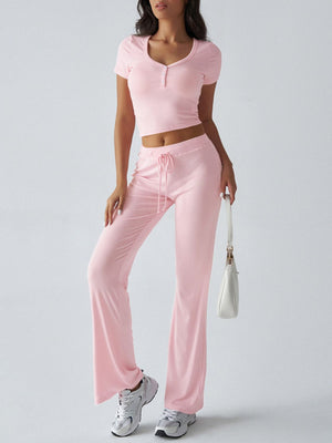 Blush pink button-front crop top and flared lounge pants with drawstring waist.
