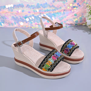 Embroidered floral wedge sandals with adjustable strap and brown accents.