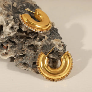 Gold cubic zirconia embellished crescent hoop earrings with a polished finish.