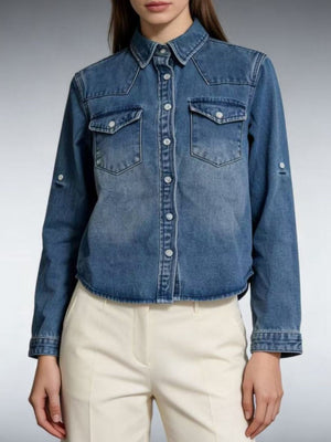 Blue denim overshirt with button-down front, chest pockets, and rolled sleeves.