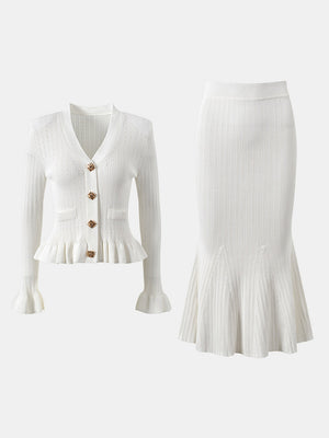 White knit cardigan with ruffled hem and bell sleeves, paired with a matching mermaid skirt.
