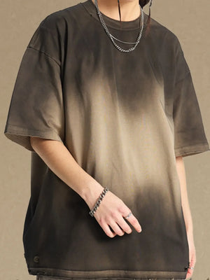 Oversized tee with faded ombre pattern in dark gray and khaki, crew neck, short sleeves.