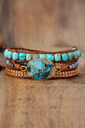 Turquoise and copper wrap bracelet set with leather cord and stone accent.