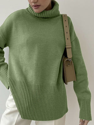 Matcha green ribbed turtleneck sweater with flared sleeves and a textured hem.