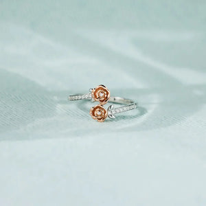 Rosebud bypass ring in silver with pavé detail and two rosebud charms.