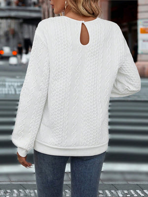 White cable-knit sweatshirt with textured pattern and keyhole back detail.