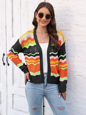 Rainbow wave crochet cardigan with black trim, open front, long sleeves, and colorful chevron pattern.