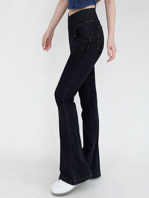 Black crossover waist flare jeans with a bootcut leg.
