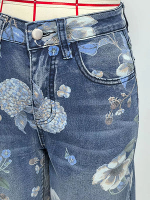 Blue denim shorts with a botanical print and relaxed fit.