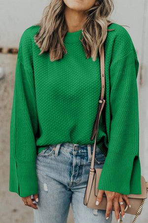 Green textured knit sweater with crew neck and split bell sleeves.