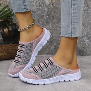 Pink knit slip-on sneakers with grey accents and black stripes, featuring a white sole.