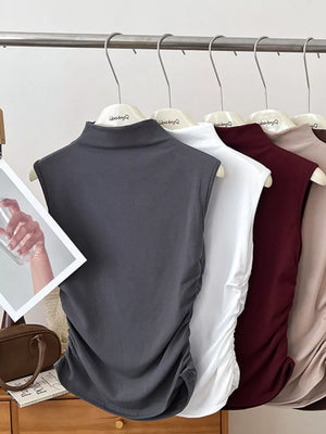 Dark gray ruched mock neck tank top with draped side detail.