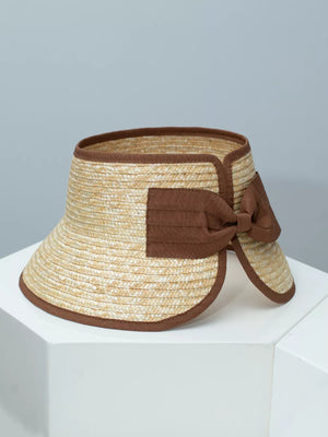 Straw visor hat in natural straw with brown trim and bow detail.