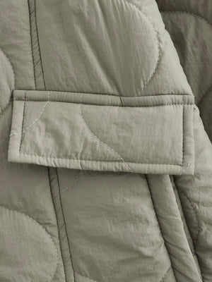 Lined quilted button-down jacket in moss green with a patch pocket and white contrast stitching.