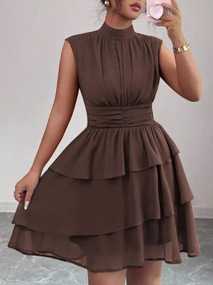 Sleeveless brown tiered ruffle dress with ruched waist and mock neck.