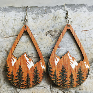 Teardrop silhouette earrings with mountain and pine tree scene, wood grain detail