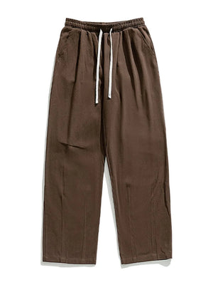 Coffee brown wide-leg pleated drawstring trousers with a relaxed fit.