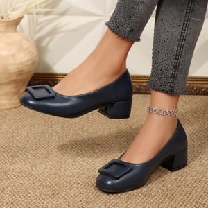 Dark blue block heel shoes with square buckle detail.