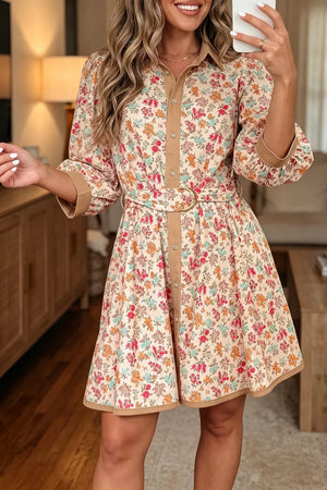 Floral print button down mini dress with color block trim and belt.