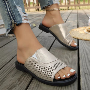 Gold hollow-out slide sandals with breathable perforated detail.