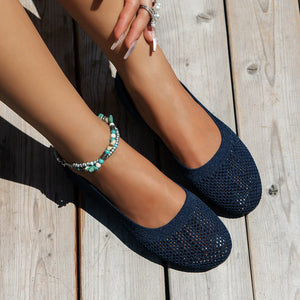 Indigo knit ballet flats with a breathable mesh texture and round toe.