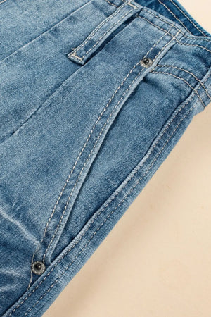 Medium wash denim trousers with button fly and contrast stitching detail.