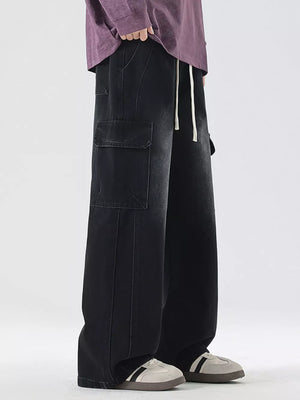 Black oversized cargo jeans with drawstring waist and large side pockets.