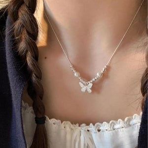 Charming butterfly and pearl necklace with delicate silver beads.