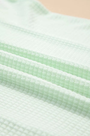 Relaxed V-neck waffle knit t-shirt in light green fabric detail