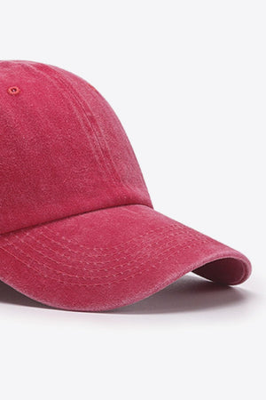 Washed cotton baseball cap in magenta with stitched brim detail.