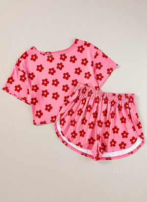 Coral pink floral crop top and shorts set with white trim on shorts.