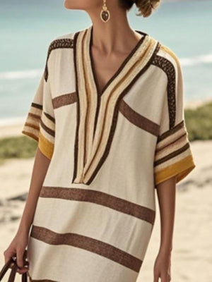 Striped midi dress in tan with brown and yellow accents, V-neck, half sleeves, and textured trim.