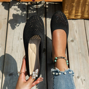 Black knit ballet flats with breathable mesh detail and cushioned insole.