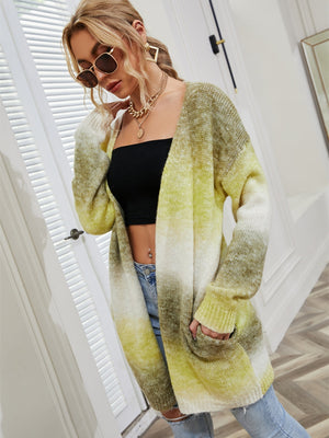 Longline knit cardigan with rainbow gradient in yellow green, white, and tan, featuring pockets.