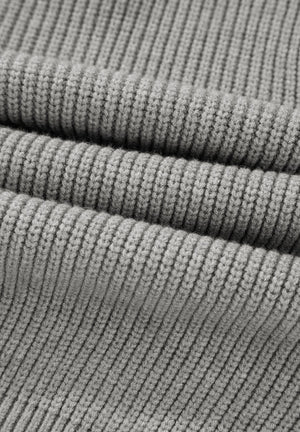 Gray ribbed knit cardigan detail showing texture and fabric weave.