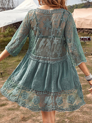 Teal lace tiered mini dress with crochet trim and floral embroidery.