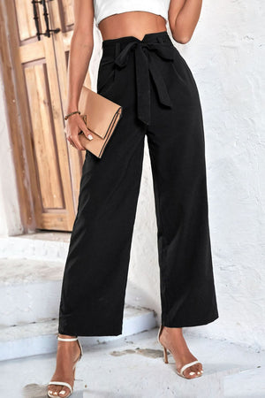 Belted high-waist palazzo trousers in black with a cinched bow tie waist and wide leg