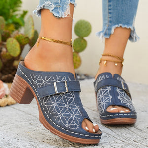 Blue buckle-embellished mid heel sandals with white floral embroidery and peep toe.